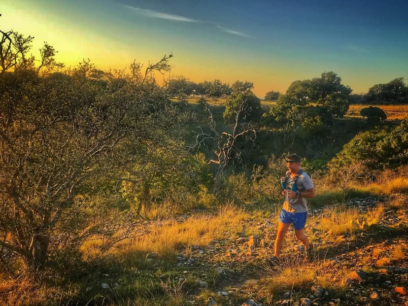 Dr. Dan Foss sprinting through a forest trail